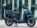 Scooter SYM Symphony SR azul, con maletero SH33. Consulta la ficha técnica para más detalles.