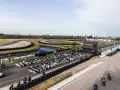 Evento en el aspar circuit con público sentado frente a un escenario. Motos alineadas en la pista.