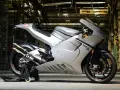 La Suter MMX 500, una moto de carreras plateada con detalles negros, lista para la pista.