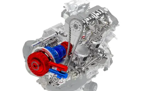 Corte detallado de un motor de moto automática, mostrando el embrague rojo y el engranaje azul.