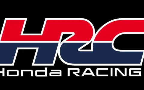 Logo HRC Honda Racing en colores rojo, azul y blanco sobre fondo negro.