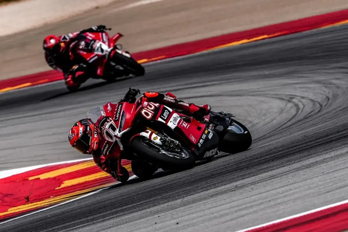 Dos pilotos de superbikes en sus motos rojas toman una curva cerrada. ¡No te pierdas el horario superbikes hoy en Teledeporte!